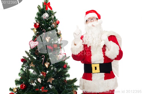 Image of santa claus with bag and christmas tree