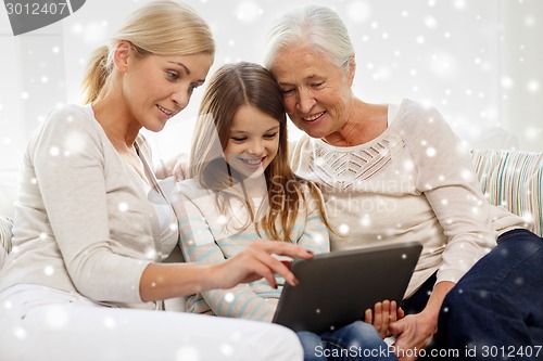 Image of smiling family with tablet pc at home