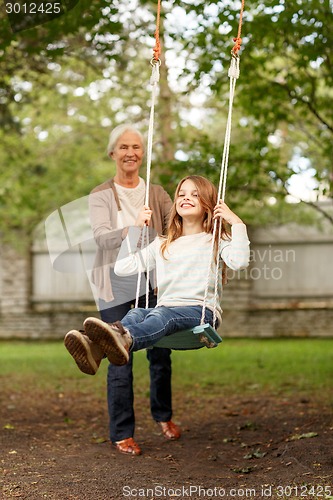 Image of happy family in front of house outdoors