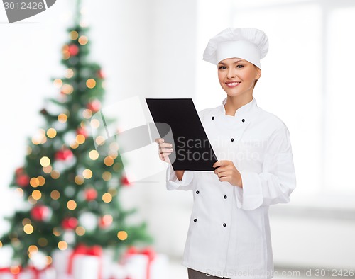 Image of smiling female chef with black blank paper