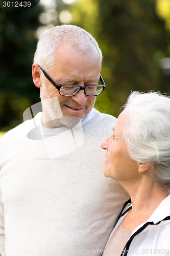 Image of senior couple hugging in city park