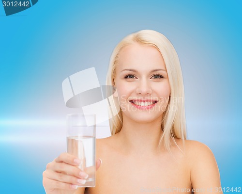 Image of young smiling woman with glass of water