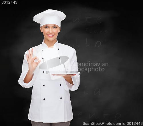 Image of smiling female chef with tablet pc computer