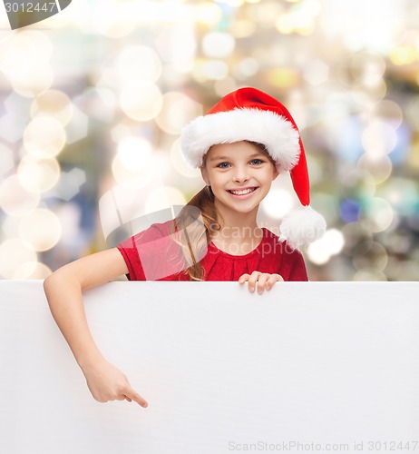 Image of girl in santa helper hat with blank white board