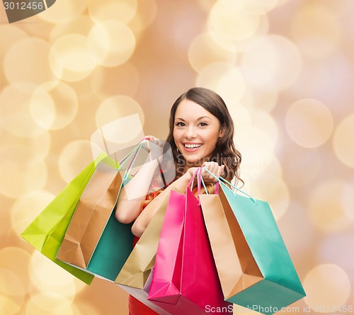 Image of smiling woman with colorful shopping bags