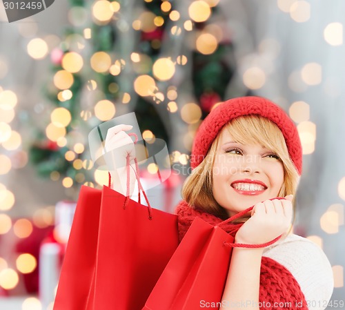 Image of smiling young woman with shopping bags