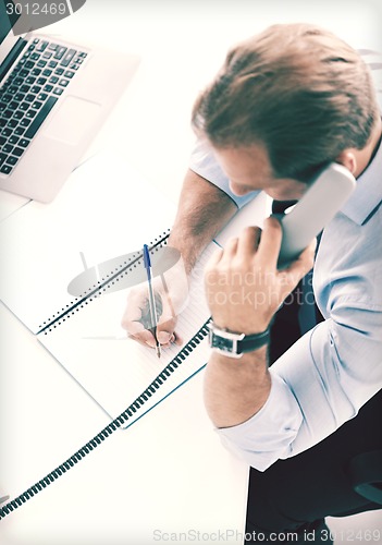 Image of handsome businessman talking on the phone