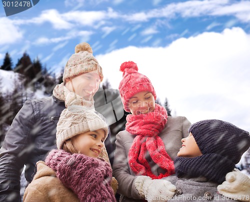 Image of happy family in winter clothes outdoors