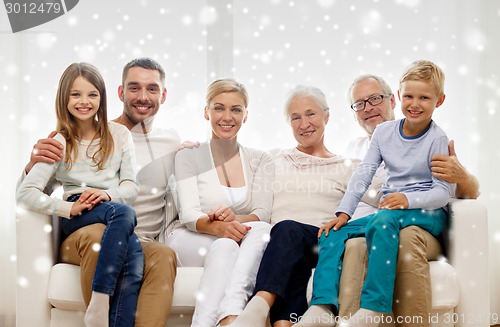 Image of happy family sitting on couch at home