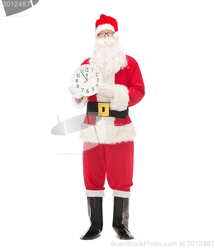 Image of man in costume of santa claus with clock