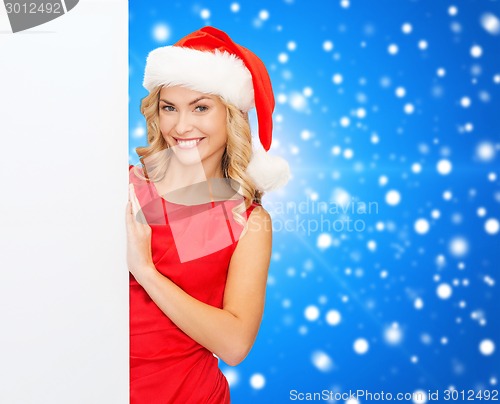 Image of smiling young woman in santa hat with white board