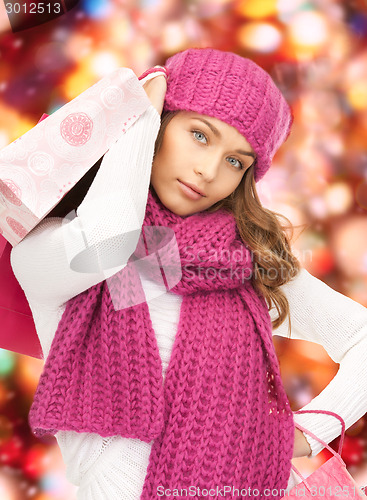 Image of smiling young woman with shopping bags