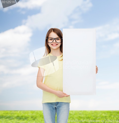 Image of little girl wearing eyeglasses with blank board