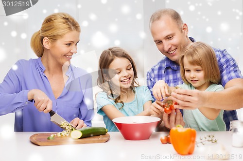 Image of happy family with two kids making dinner at home