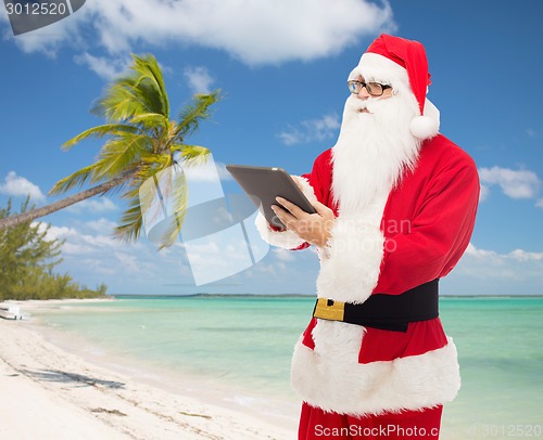 Image of man in costume of santa claus with tablet pc