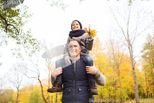 Image of happy family having fun in autumn park