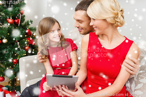 Image of smiling family with tablet pc at home