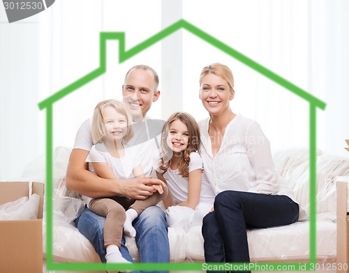 Image of smiling parents and two little girls at new home