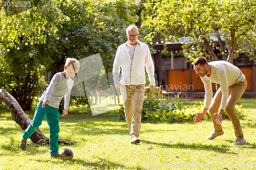 Image of happy family playing football outdoors