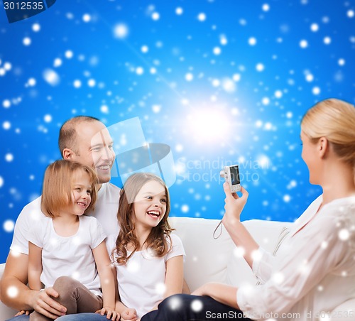 Image of happy family with camera at home