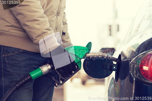 Image of close up of male refilling car fuel tank