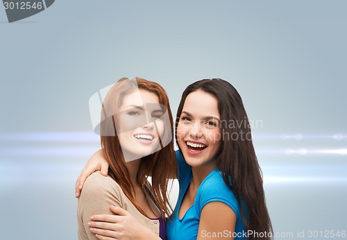 Image of smiling teenage girls hugging