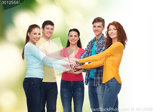 Image of group of smiling teenagers over green background