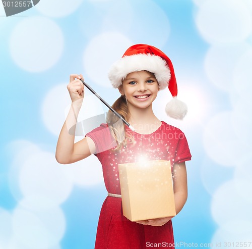 Image of smiling girl in santa helper hat with gift box