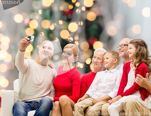 Image of smiling family with camera