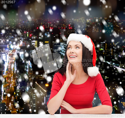 Image of smiling woman in santa helper hat