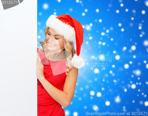 Image of smiling young woman in santa hat with white board