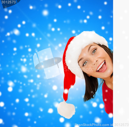 Image of woman in santa helper hat with blank white board