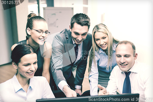Image of business team with monitor having discussion
