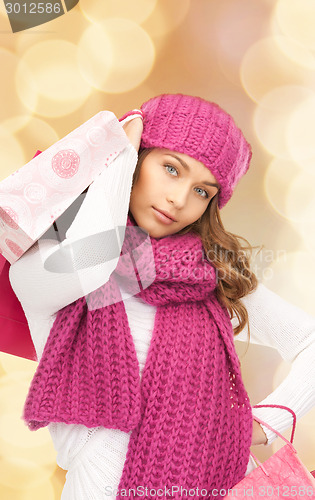 Image of smiling young woman with shopping bags