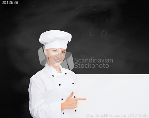 Image of smiling female chef with white blank board