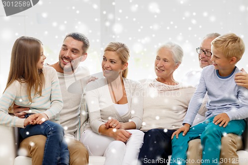 Image of happy family sitting on couch at home