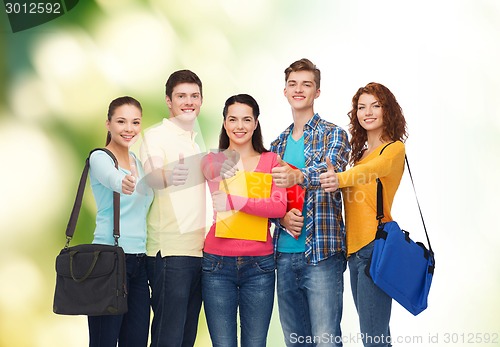 Image of group of smiling teenagers showing thumbs up