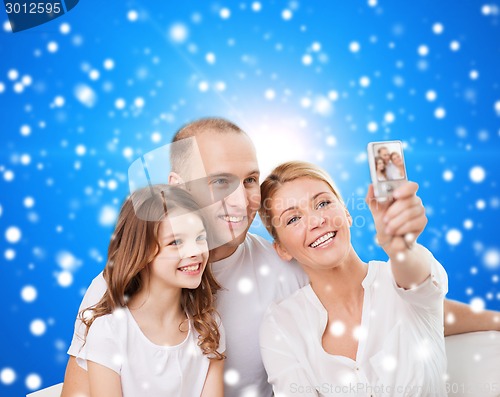 Image of happy family with camera at home