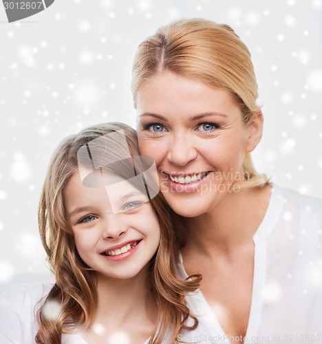 Image of smiling mother and little girl