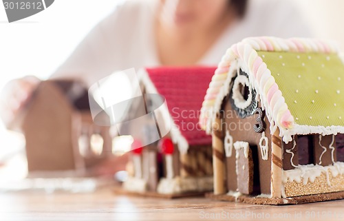 Image of close up of woman making gingerbread houses