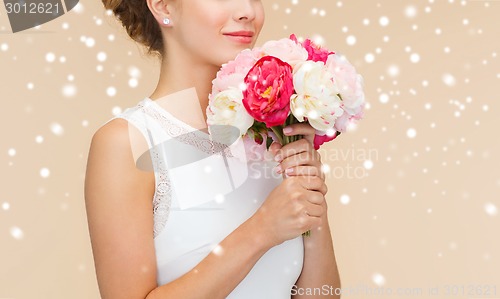 Image of close up of woman in white dress with flowers