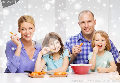 Image of happy family with two kids making dinner at home