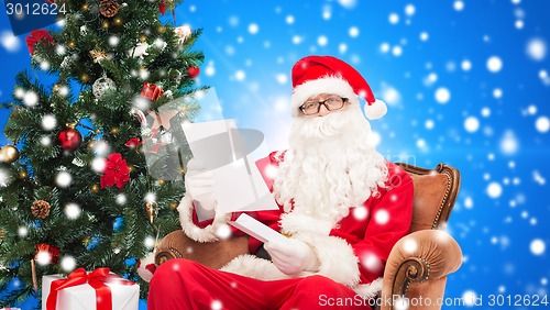 Image of man in costume of santa claus with letter