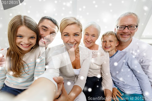Image of happy family taking selfie at home