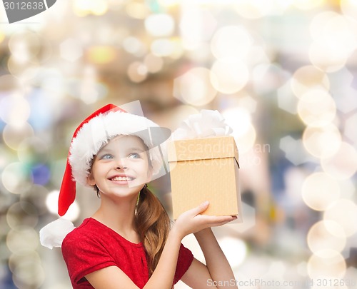 Image of smiling girl in santa helper hat with gift box