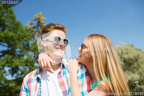 Image of smiling couple having fun outdoors
