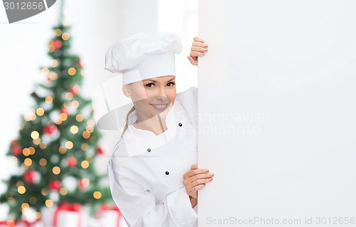 Image of smiling female chef with white blank board