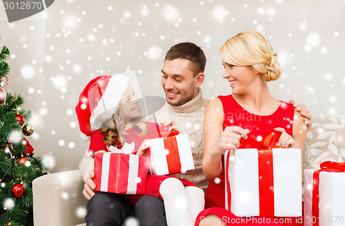 Image of smiling family holding many gift boxes