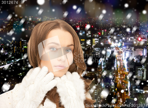 Image of smiling young woman in winter clothes