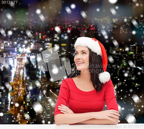 Image of smiling woman in santa helper hat